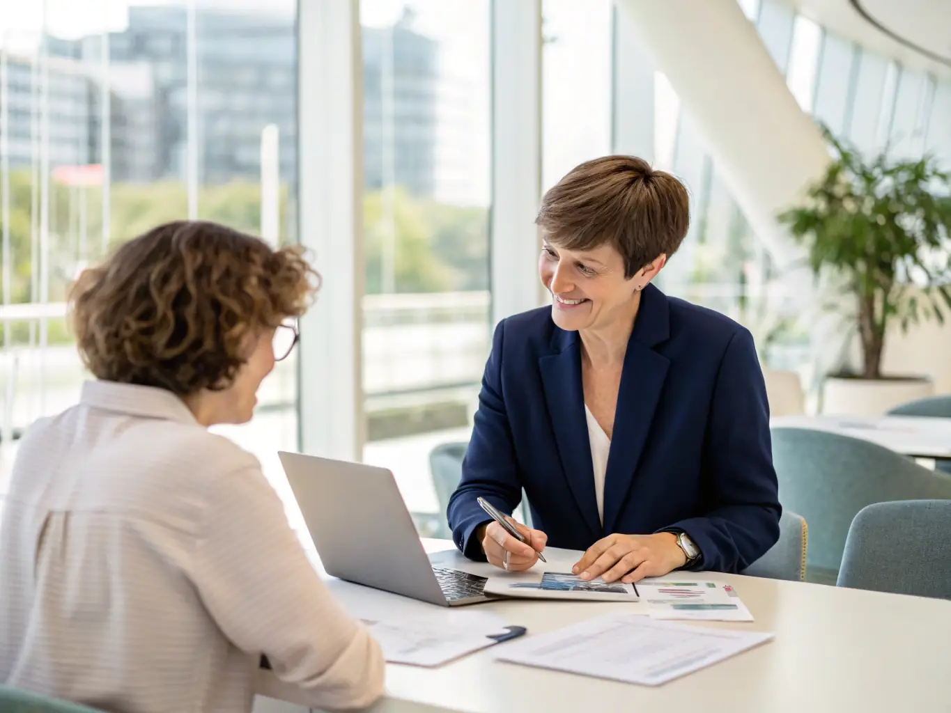 A financial advisor meeting with a client, discussing their financial goals and providing personalized advice in a Canadian context.